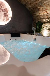 a bathroom with a bath tub with a water fountain at Luna Gemella Suite & SPA in Calitri