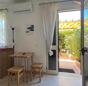 a kitchen with a table and a door to a patio at Da Elio Case Vacanza e Stanze in San Domino