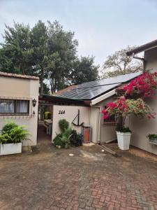 a house with a brick driveway in front of it at Ulu Garden Cottage in Ramsgate