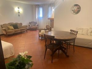 a living room with a table and chairs and a bed at Villa Rosa in Borso del Grappa +5 photos