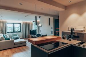 a kitchen and living room with a couch and a table at Auszeit3 in Wallenfels