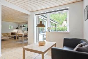 a living room with a couch and a table at 8837-Glesborg-Enebaervej-30-A in Glesborg +18 photos