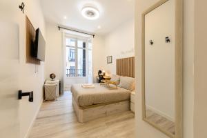 a bedroom with a bed and a mirror at Washington habitación con comodidad y zonas compartidas Gran Vía-Madrid Temporal SBE104 in Madrid