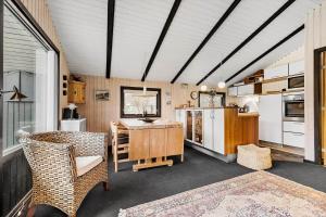 a kitchen with a table and chairs in a room at 8531-Grenaa-Annettevej-9 in Brøndstrup +17 photos