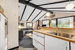 a kitchen with a sink and a living room at 8531-Grenaa-Annettevej-9 in Brøndstrup
