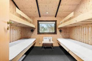 a room with two beds and a desk in it at 8531-Grenaa-Annettevej-9 in Brøndstrup