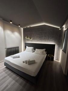 a bedroom with a large bed with two candles on it at Michelangelo Etna Hotel in Nicolosi +63 photos