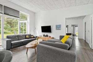 a living room with two couches and a tv at 8835-Glesborg-Skovsoen-50 in Glesborg