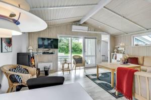 a living room with a table and a couch at 8533-Grenaa-Fridavej-2 in Brøndstrup