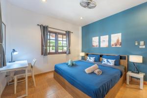 a blue bedroom with a bed and a desk at Serenity Holiday Villa 2, Karon Beach in Karon Beach
