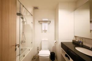 a bathroom with a toilet and a sink and a tub at The Kaset, Hua Hin in Hua Hin