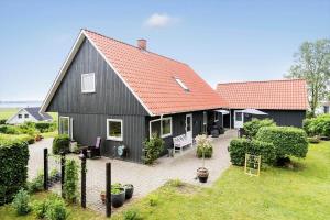 a black house with a red roof at 8997-Orsted-Rougsovej-326-B in Ørsted