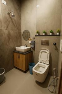 a bathroom with a toilet and a sink at 2BHK Luxury Villa In Mohali GF - Stay Royal in Mohali