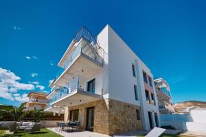 a white building with a balcony on the side at Luxury apartment Tamana Blue - by Welcomely in Jávea +22 photos
