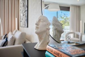 a sculpture of a head on a table in a living room at Luxury apartment Tamana Blue - by Welcomely in Jávea