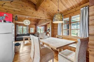 a kitchen and dining room with a table and a refrigerator at 84249-Knebel-Skraningen-13 in Knebel