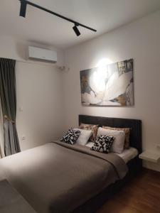 a bedroom with a bed with pillows on it at Sky View N&N Near Airport, Highway & Free Parking in Skopje