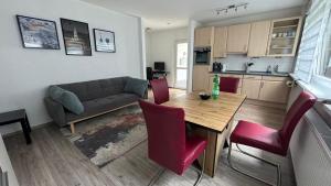 a living room with a couch and a table and chairs at Beethoven Apartments in Solingen