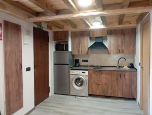 a kitchen with a washing machine and a washer at La Casa de Pepe in Muros de Nalón
