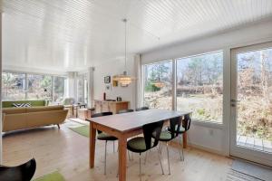 a living room with a wooden table and chairs at 1465-N-Frederiksvaerk-Skovsneppevej-6 in Frederiksværk
