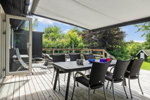 a patio with a table and chairs on a deck at 1586-Melby-Anna-Borgsvej-19 in Melby