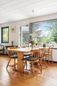 a dining room with a wooden table and chairs at 1586-Melby-Anna-Borgsvej-19 in Melby