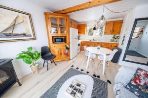a living room with a table and a kitchen at Spa & River view - Le Jardin in Montmagny
