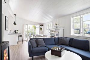 a living room with a blue couch and a table at 872-N-Melby-Reinsholmvej-15 in Melby