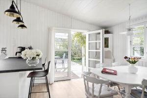 a kitchen and dining room with a white table and chairs at 872-N-Melby-Reinsholmvej-15 in Melby +15 photos
