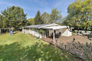 a white house with a deck and a yard at 872-N-Melby-Reinsholmvej-15 in Melby