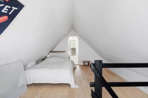 a bedroom with a white bed in a attic at 1480-N-Liseleje-Hellevej-9 in Liseleje