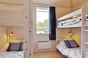 a bedroom with two bunk beds and a window at 902-N-Tisvildeleje-Klovervej-9 in Tisvildeleje
