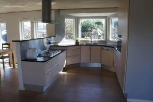 a kitchen with a sink and a stove top oven at 1606-Liseleje-Lisevaenget-18 in Liseleje +27 photos
