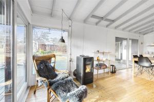 a living room with a fireplace and a table at 1158-N-Liseleje-Rugskellet-9 in Liseleje