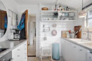 a kitchen with white cabinets and a sink at 1401-N-Liseleje-Korntoften-9 in Liseleje