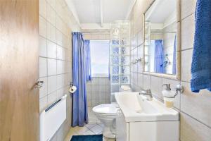 a bathroom with a sink and a toilet and a window at 1158-N-Liseleje-Rugskellet-9 in Liseleje