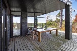 a wooden deck with a table and chairs on it at 1164-N-Melby-Bjergvej-7 in Melby +16 photos