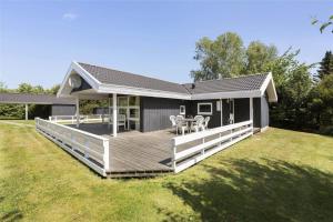 a house with a large deck in the yard at 617-N-Melby-Bakkely-8-B in Melby