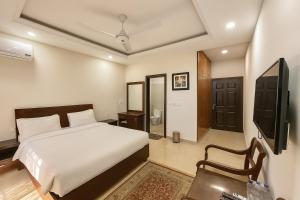 a bedroom with a bed and a tv in it at Ziel Hotels & Guest House Islamabad Near US Embassy & VFS Global in Mohra Nūr