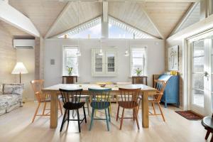 a kitchen and dining room with a table and chairs at 1517-Melby-Lindebjergvej-78 in Melby