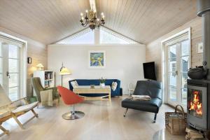 a living room with a chandelier and a fireplace at 1517-Melby-Lindebjergvej-78 in Melby