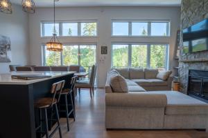 a living room with a couch and a bar with a fireplace at LAKE and SPA - Le Matit 21 in Saint Come +38 photos