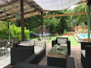 a patio with a pergola and a pool at Maison belle-vie in Corconne