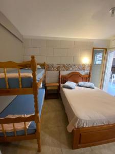 a bedroom with two bunk beds in a room at Pousada da Marli in Torres