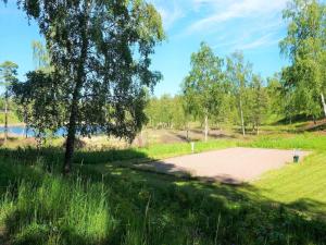 a basketball court in a field with a tree at 4 person holiday home in AXVALL in Axvall