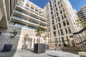 two tall buildings with trees in front of them at New apartment in the heart of Jerusalem ! in Jerusalem