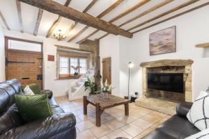 a living room with a couch and a fireplace at Charming 3-Bed Cottage in Central Stroud in Gloucestershire