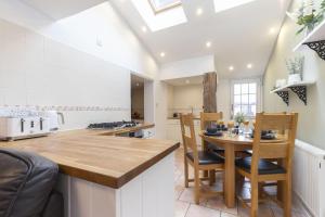 a kitchen with a wooden table and chairs at Charming 3-Bed Cottage in Central Stroud in Gloucestershire
