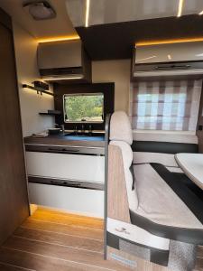 a small room with a tv in a rv at RWay The Moving Hotel by Theo in Budapest