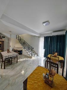 a living room with a table and chairs and a fireplace at CASA DE SUB MAGURA in Simeria